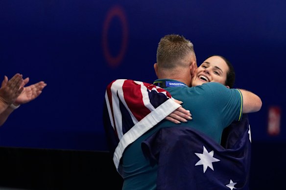 Kaylee McKeown knuffelt de Australische hoofdcoach Rohan Taylor na haar overwinning. 